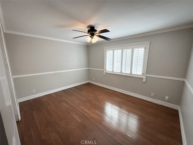 spare room featuring ceiling fan, crown molding, dark wood-style floors, and baseboards