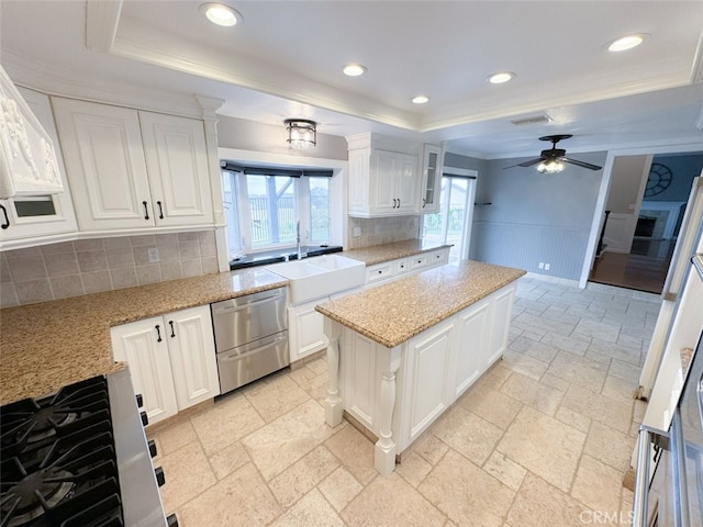 kitchen featuring appliances with stainless steel finishes, a sink, white cabinetry, visible vents, and a raised ceiling