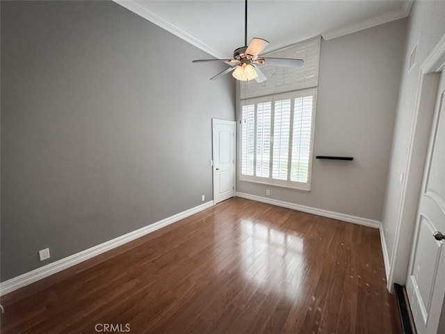 empty room featuring wood finished floors, ceiling fan, ornamental molding, and baseboards