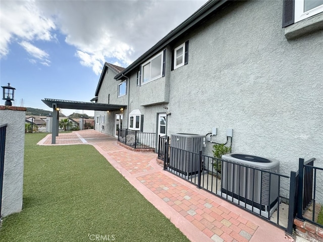 view of patio / terrace with central AC and fence