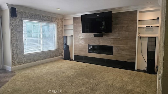 24722 Bracken Ln, Stevenson Ranch, CA 91381 - unfurnished living room featuring crown molding, baseboards, a tiled fireplace, and built in features
