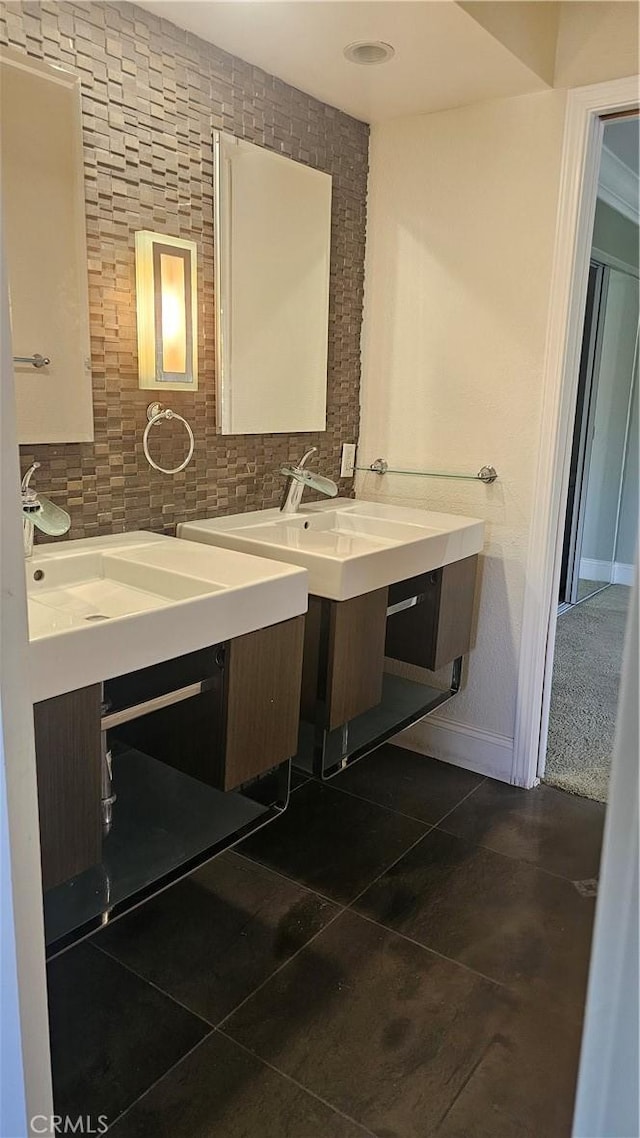 24722 Bracken Ln, Stevenson Ranch, CA 91381 - bathroom featuring tile patterned flooring, baseboards, two vanities, a sink, and backsplash