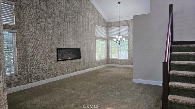 24722 Bracken Ln, Stevenson Ranch, CA 91381 - unfurnished living room featuring carpet flooring, a chandelier, stairs, baseboards, and lofted ceiling