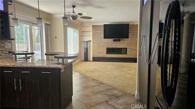 24722 Bracken Ln, Stevenson Ranch, CA 91381 - kitchen with carpet floors, freestanding refrigerator, ornamental molding, ceiling fan, and a tile fireplace