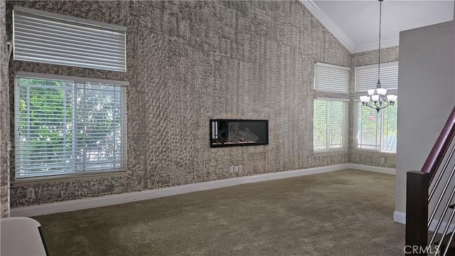 24722 Bracken Ln, Stevenson Ranch, CA 91381 - unfurnished living room with crown molding, baseboards, lofted ceiling, an inviting chandelier, and carpet