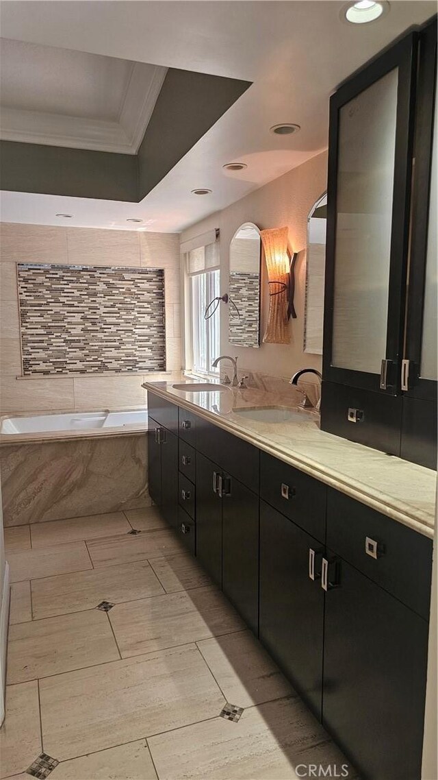 24722 Bracken Ln, Stevenson Ranch, CA 91381 - full bathroom featuring crown molding, vanity, recessed lighting, a raised ceiling, and a bath