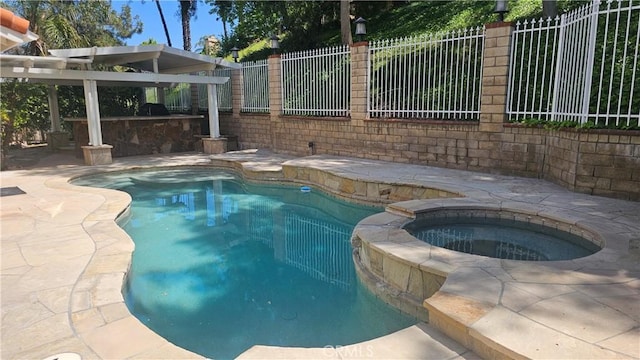 24722 Bracken Ln, Stevenson Ranch, CA 91381 - view of pool with an outdoor kitchen, a pool with connected hot tub, a fenced backyard, and a patio area
