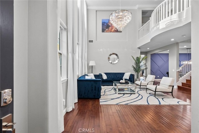 20704 Campania Ln, Porter Ranch, CA 91326 - living room with crown molding, stairway, visible vents, wood finished floors, and a notable chandelier