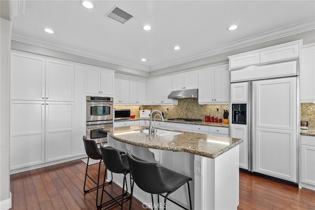20704 Campania Ln, Porter Ranch, CA 91326 - kitchen with a sink, appliances with stainless steel finishes, visible vents, ornamental molding, and dark wood-type flooring