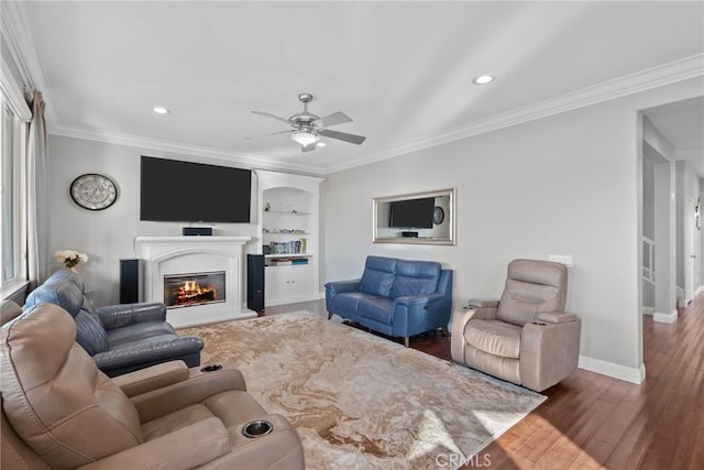 20704 Campania Ln, Porter Ranch, CA 91326 - living room with baseboards, a glass covered fireplace, ornamental molding, wood finished floors, and built in features