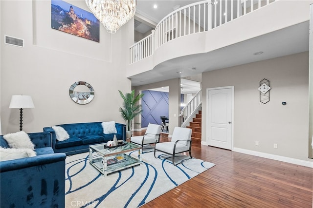 20704 Campania Ln, Porter Ranch, CA 91326 - living room with wood finished floors, an inviting chandelier, stairs, baseboards, and visible vents