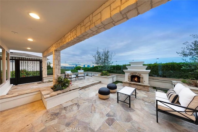 view of patio / terrace with an outdoor living space with a fireplace
