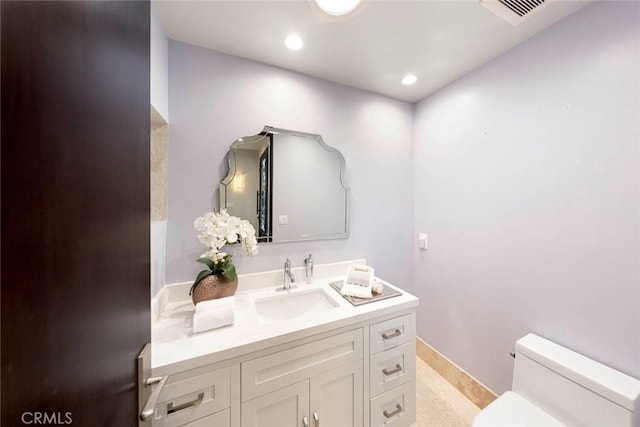 bathroom featuring visible vents, baseboards, toilet, recessed lighting, and vanity