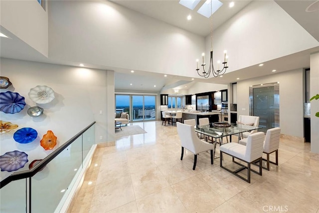 dining room featuring recessed lighting, a skylight, light tile patterned floors, a notable chandelier, and a high ceiling