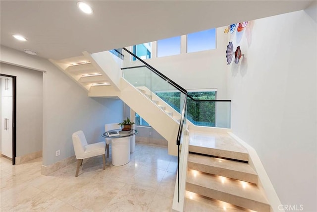 stairs featuring recessed lighting and baseboards