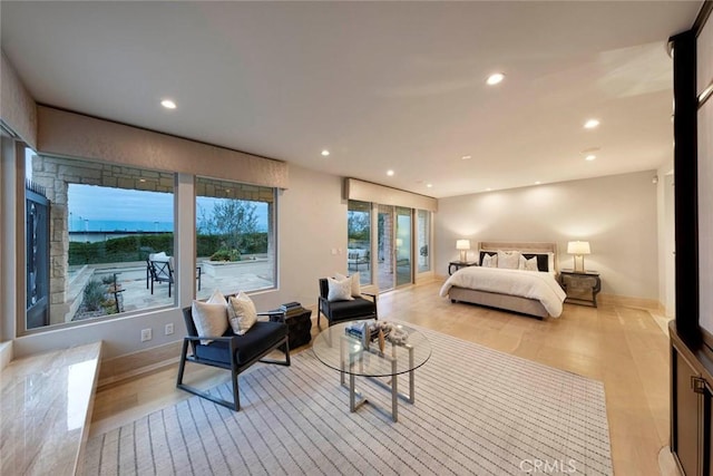 bedroom with baseboards, recessed lighting, access to exterior, and light wood-style floors