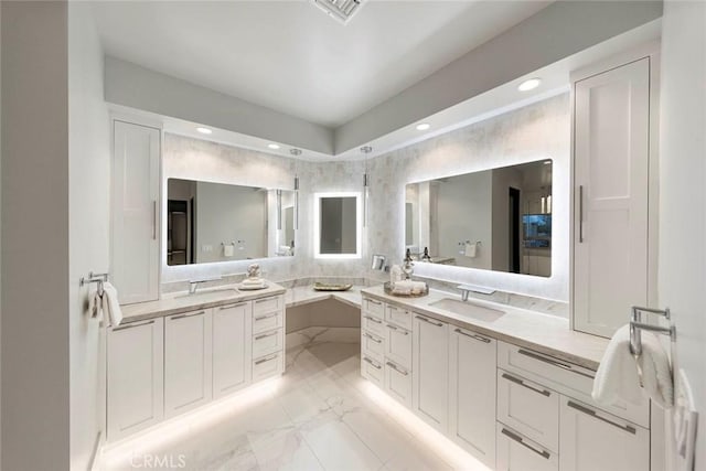 full bath featuring visible vents, recessed lighting, marble finish floor, and vanity