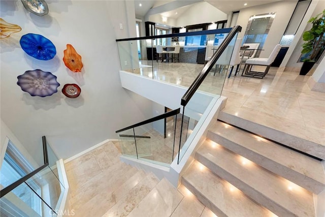 staircase with tile patterned floors and baseboards