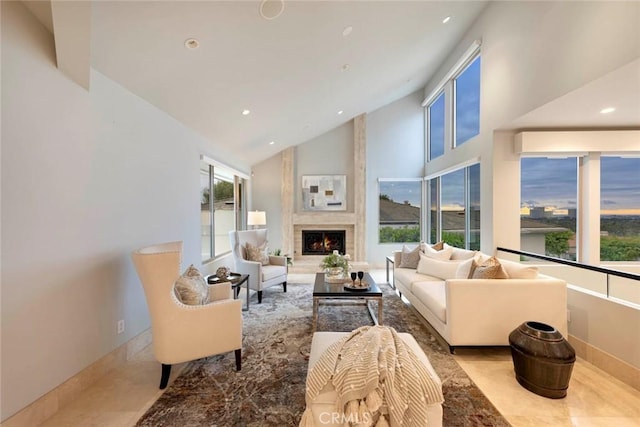 living room featuring a fireplace, recessed lighting, high vaulted ceiling, and baseboards