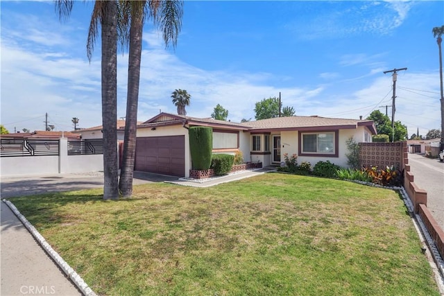 ranch-style home featuring driveway, fence, a front lawn, an attached garage, and stucco siding