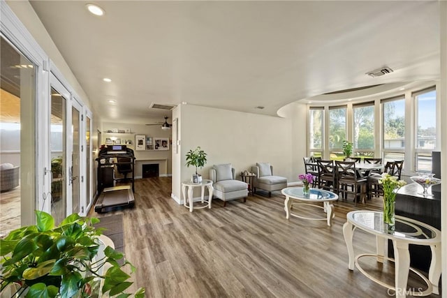 living area featuring recessed lighting, visible vents, ceiling fan, and wood finished floors