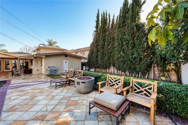 view of patio with a fire pit and grilling area