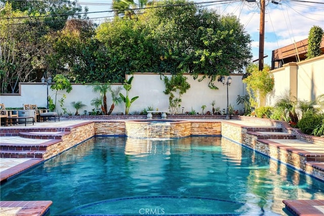 view of pool with a patio area, a pool with connected hot tub, and a fenced backyard