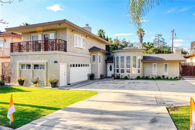 view of front of home with a balcony, stucco siding, a chimney, concrete driveway, and an attached garage