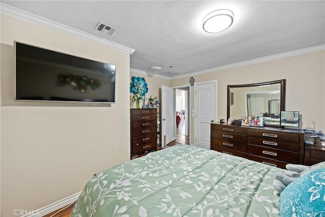 bedroom featuring baseboards, visible vents, and crown molding
