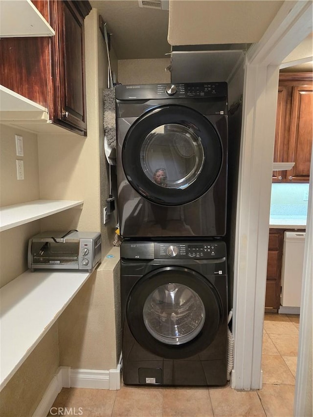 443 Hartman Cir, Cedarpines Park, CA 92322 - washroom with stacked washer / dryer, light tile patterned floors, and baseboards