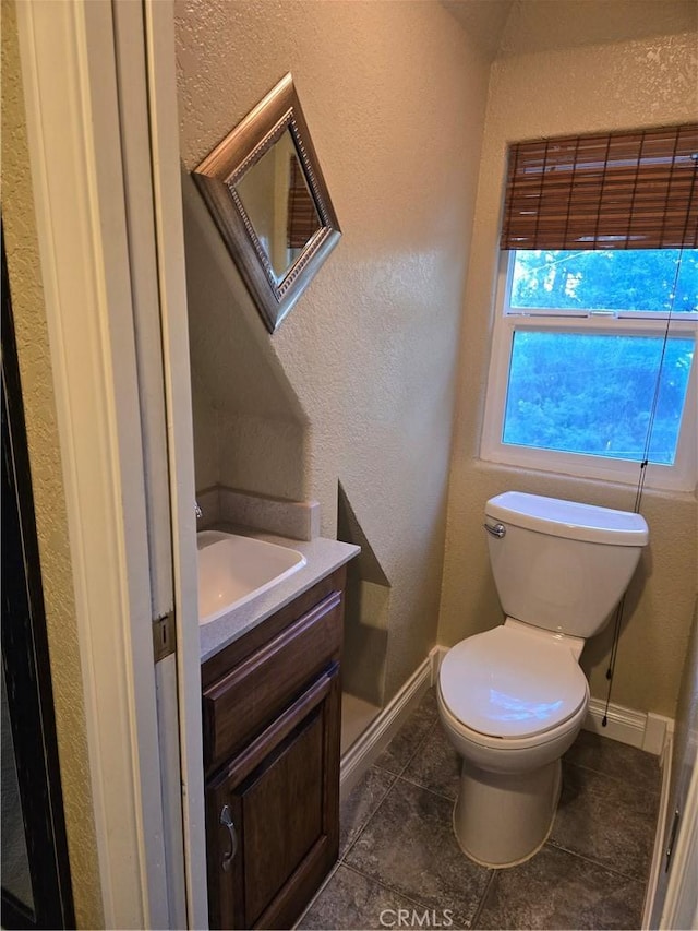 443 Hartman Cir, Cedarpines Park, CA 92322 - bathroom featuring a textured wall, vanity, toilet, baseboards, and tile patterned floors
