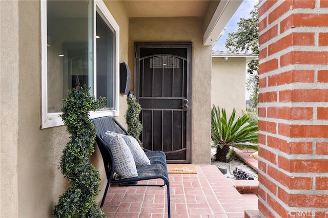 entrance to property with stucco siding