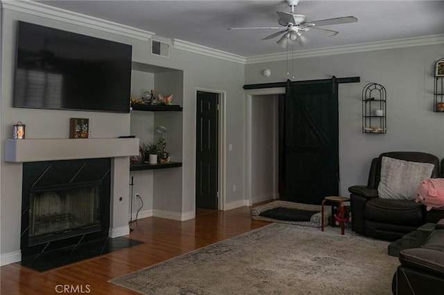 27069 Dawnview Ct, Corona, CA 92883 - living area featuring a barn door, visible vents, ceiling fan, and wood finished floors