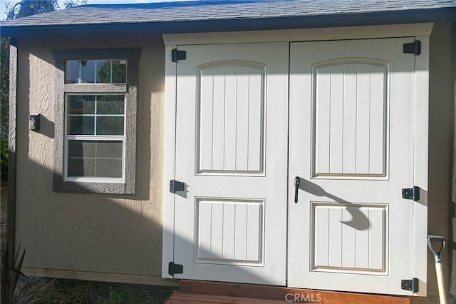 27069 Dawnview Ct, Corona, CA 92883 - view of exterior entry with stucco siding and roof with shingles