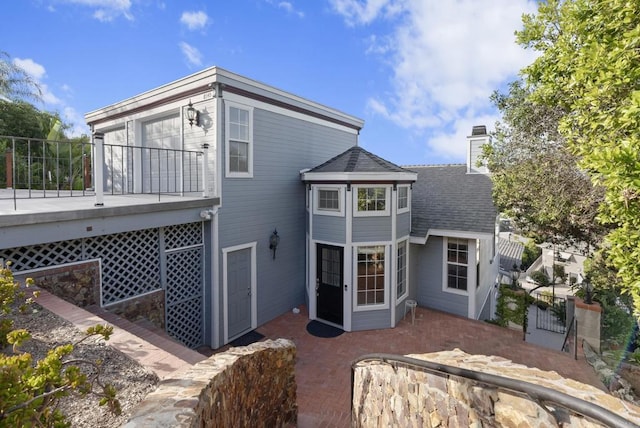 8140 Pasadena Ave, La Mesa, CA 91941 - back of house featuring a chimney, a wooden deck, a shingled roof, and fence