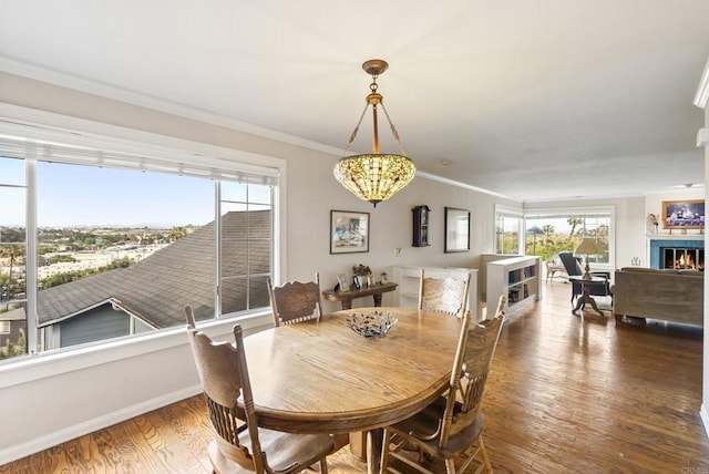 8140 Pasadena Ave, La Mesa, CA 91941 - dining space featuring a warm lit fireplace, wood finished floors, ornamental molding, an inviting chandelier, and baseboards