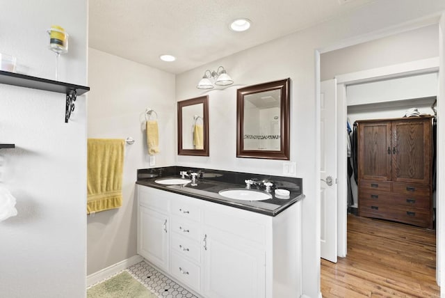8140 Pasadena Ave, La Mesa, CA 91941 - bathroom with baseboards, recessed lighting, double vanity, and a sink