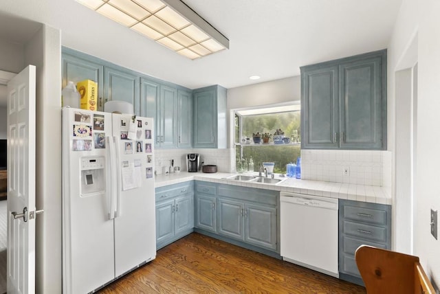 8140 Pasadena Ave, La Mesa, CA 91941 - kitchen with a sink, dark wood finished floors, white appliances, tile countertops, and decorative backsplash