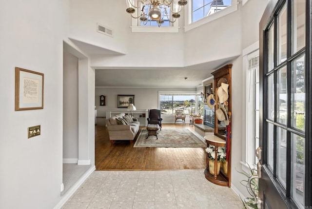 8140 Pasadena Ave, La Mesa, CA 91941 - entrance foyer featuring baseboards, visible vents, tile patterned floors, a chandelier, and a towering ceiling
