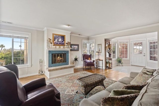 8140 Pasadena Ave, La Mesa, CA 91941 - living area featuring crown molding, baseboards, light wood-style flooring, and a glass covered fireplace