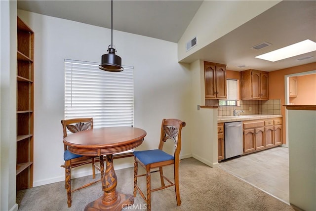 dining room featuring visible vents, light carpet, and lofted ceiling