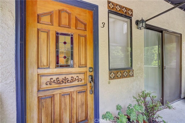 entrance to property with stucco siding