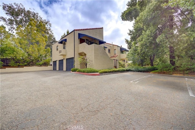 view of home's exterior with a garage and stucco siding