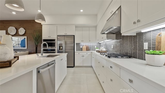 kitchen featuring decorative backsplash, stainless steel appliances, under cabinet range hood, white cabinets, and a sink