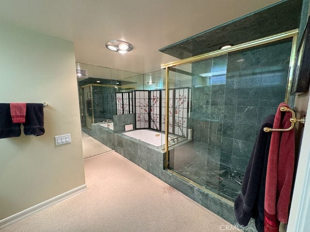 full bathroom featuring a garden tub, a shower stall, and baseboards