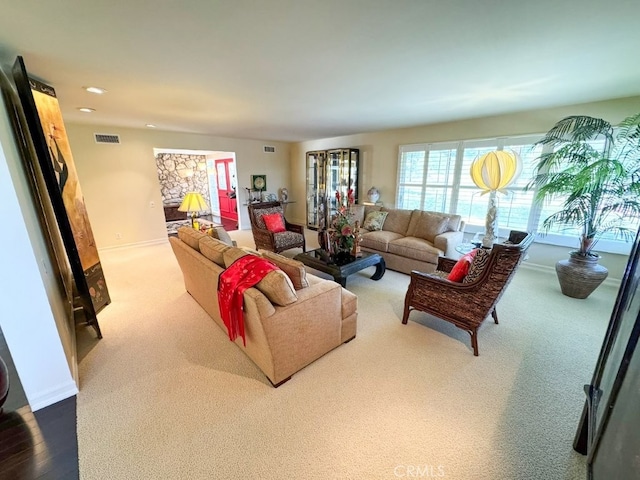 carpeted living room featuring visible vents, recessed lighting, and baseboards