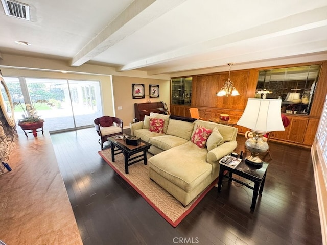 living area with beam ceiling, visible vents, a chandelier, and dark wood-type flooring