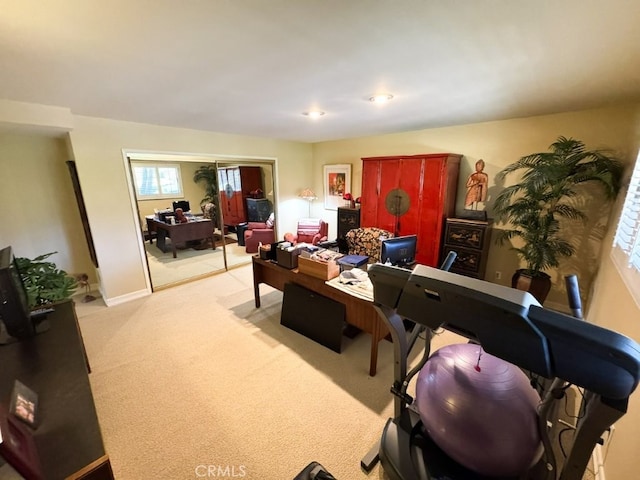 office area with baseboards and light carpet