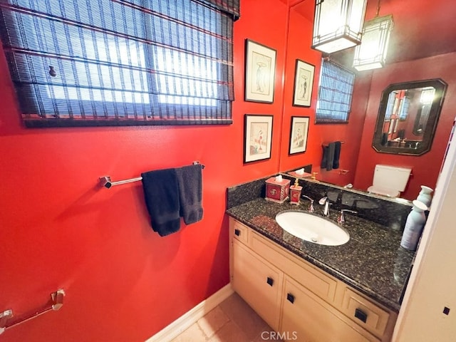 bathroom featuring tile patterned flooring, vanity, and baseboards