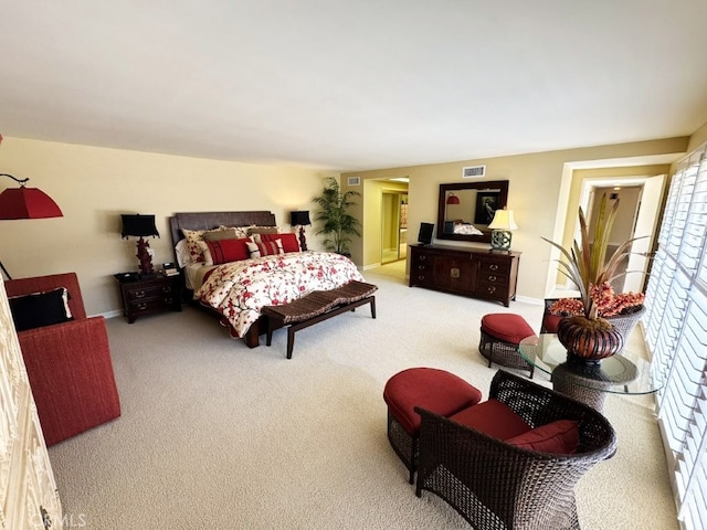 carpeted bedroom featuring visible vents and baseboards